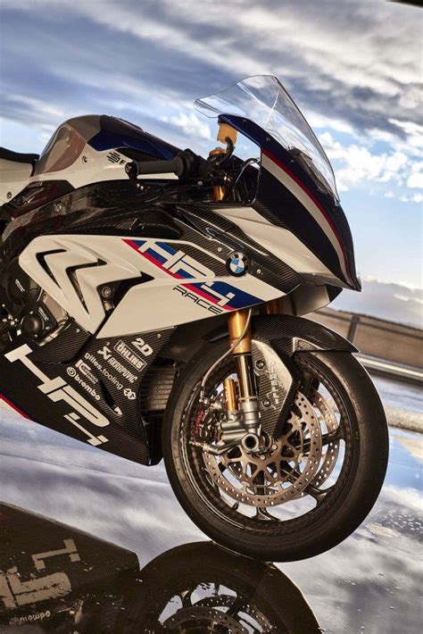 A White And Black Motorcycle Parked On Top Of A Parking Lot