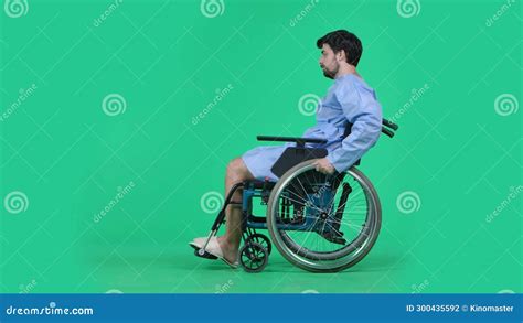 Adult Man Patient In Robe Sitting In Wheelchair And Riding On It