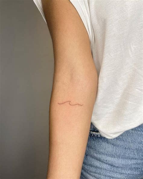 Minimalistic Wave Tattoo Located On The Inner Arm