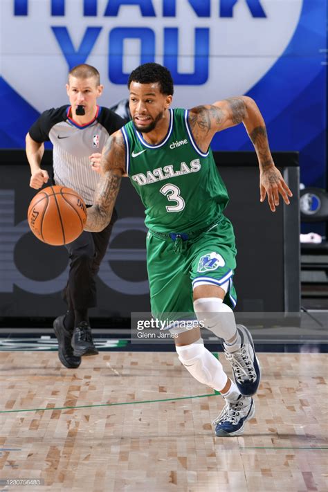 Trey Burke of the Dallas Mavericks dribbles the ball during the game... | Trey burke, Dallas ...