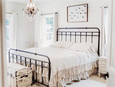 A Bedroom With A Bed Dresser And Chandelier Hanging From The Ceiling