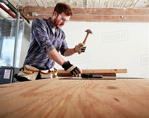 Carpenter In Workshop Using Hammer Stock Photo Dissolve