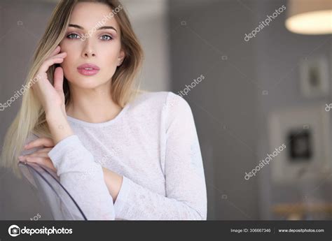 Amazing Blue Eyed Blond Woman Smiling To Camera Indoor Portrait Stock