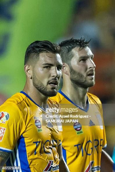 Andy Delort and Andre Gignac of Tigres get off the field at the end ...