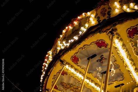 Children's Carousel at an amusement park in the evening and night ...