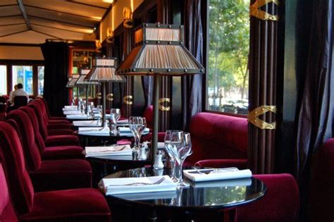 A Restaurant With Red Velvet Chairs And Tables