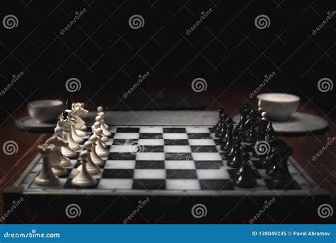 Chess Pieces on the Chessboard. Dark Background and Smoke Stock Image ...