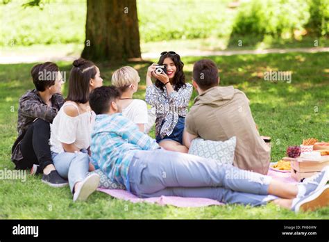 friends photographing at picnic in summer park Stock Photo - Alamy