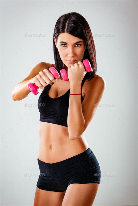 Woman Doing Exercise With Dumbbells Stock Photo By Micens PhotoDune