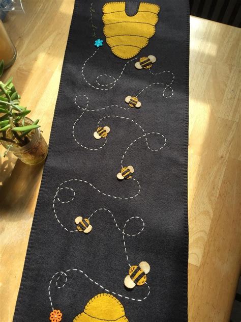 Primitive Bee Hive Skep Table Runner Is A Black Background With Hives