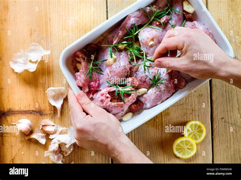 Raw Fresh Rabbit Meat With Salt Pepper Rosemary Leaves And Garlic On