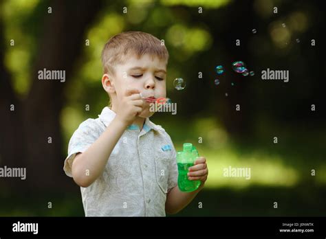 Boy Inflates Bubbles In Summer Park Stock Photo Alamy