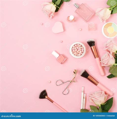 Makeup Products Decorative Cosmetics And Pink Roses On Pink Background Flat Lay Stock Image