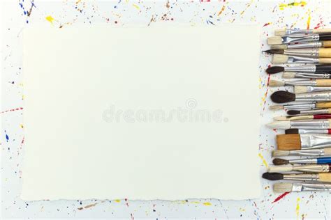 Various Paintbrushes And Blank Paper Sheet On Background With Water