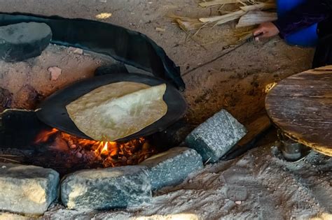 Premium Photo Pita Bread Cooking On Fire In A Bedouin Dwelling