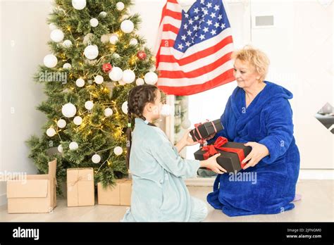 grandmother and granddaughter christmas with usa flag Stock Photo - Alamy