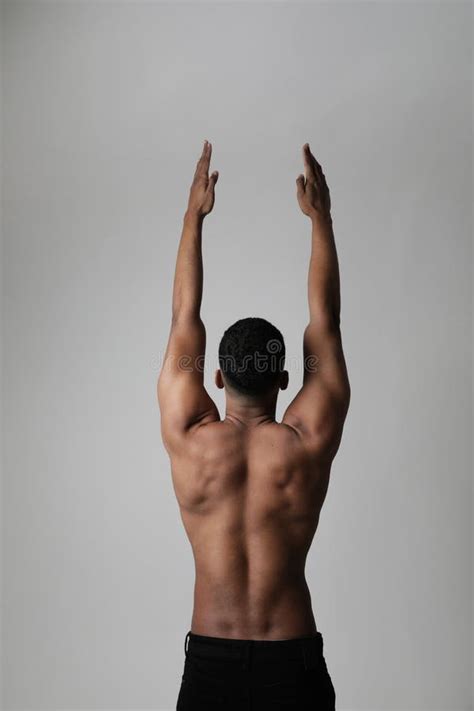 Back View Of Strong Athletic Black Man Shows Naked Muscular Body