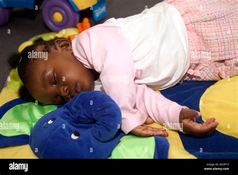 Baby sleeping in creche London UK Stock Photo - Alamy