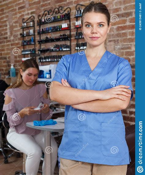 Young Smiling Girl Manicurist Standing In Modern Nail Salon Stock Image