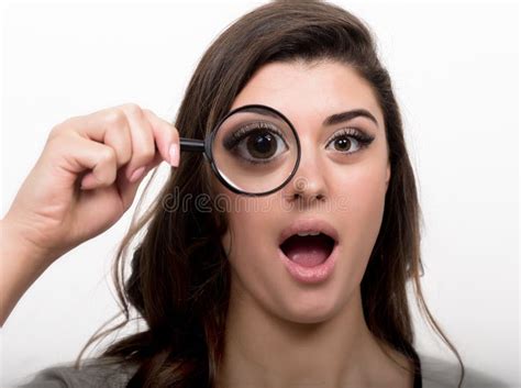 Portrait Of Young Woman Looking Through Magnifying Glass Stock Image