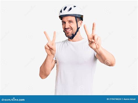 Young Handsome Man Wearing Bike Helmet Smiling Looking To The Camera