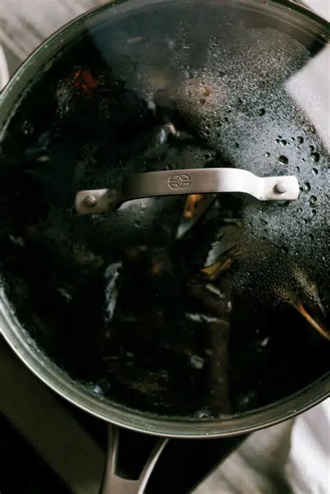 Mussels in cream sauce over fries - Dad With A Pan