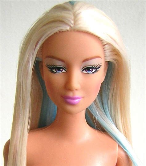 A Barbie Doll With Blonde Hair And Blue Eyes