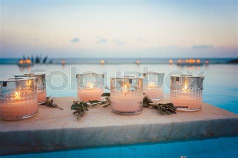 Candles floating in swimming pool at ... | Stock image | Colourbox