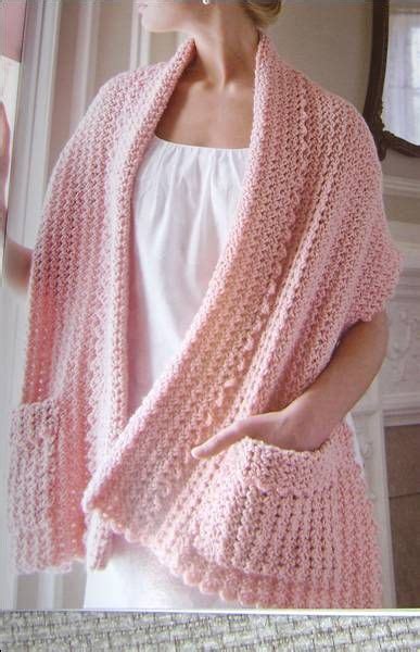 A Woman Wearing A Pink Crocheted Shawl And White Shirt With Her Hands On Her Hips