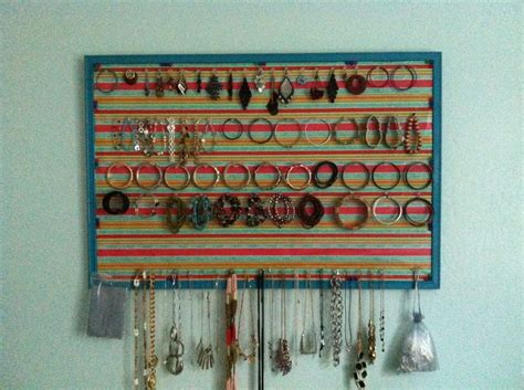 A Wall Mounted Jewelry Rack With Lots Of Earrings