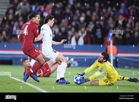 Liverpool goalkeeper Alisson Becker (right) makes a save Stock Photo - Alamy