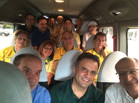 A Group Of People Sitting In The Back Of A Bus With Their Heads Turned