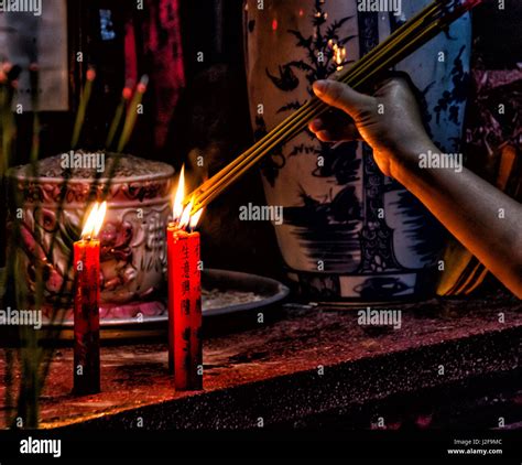 Woman Lighting Candles In A Buddhist Temple Honoi Vietmnam Stock