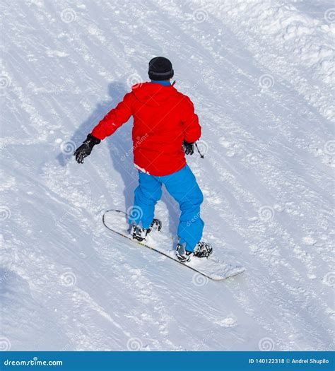 A Man Snowboarding A Mountain In The Snow In Winter Stock Photo Image