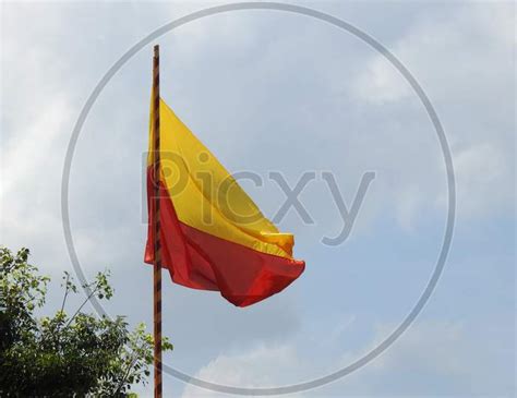 Image Of Beautiful Karnataka Yellow And Red Color Flag Waving Or Flying In A Sky Background