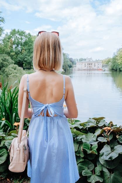 Premium Photo Attractive Blonde Woman Looking At Palace And Lake In