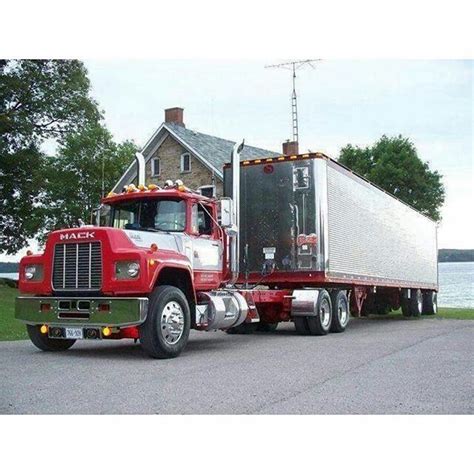 A Red Semi Truck Parked In Front Of A House