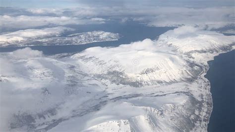 View From Plane Window Over Snow Covered Troms Norway Stock Photo