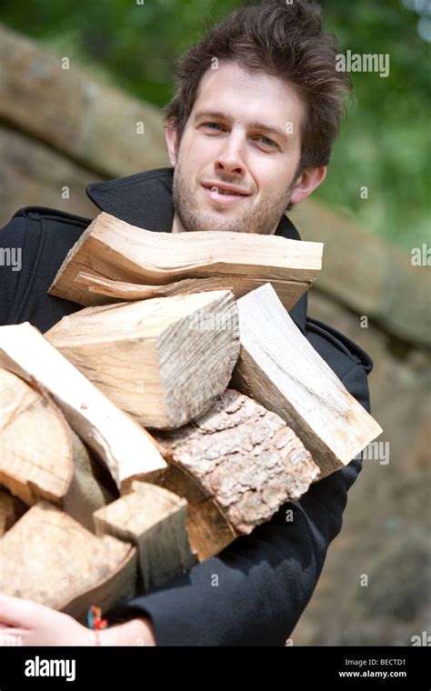 Man Holding A Pile Of Fire Wood Stock Photo Alamy