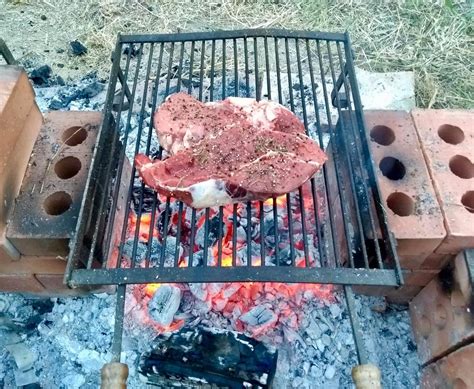 1 kg (35 oz) Chianina steak on a wood fire pit in the hills of Tuscany, Italy. Never tried ...