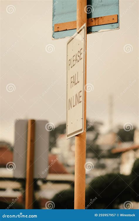 Vertical Closeup of a Road Sign with "please Fall in Line" Inscription ...