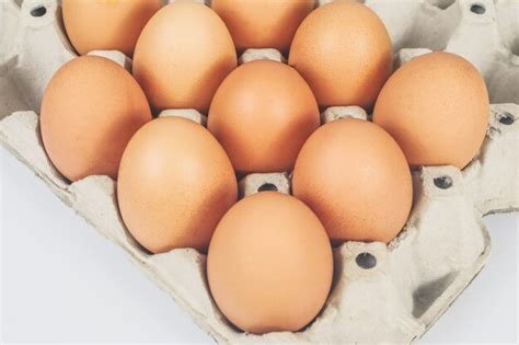 Premium Photo Raw Chicken Eggs In Egg Box On White Background