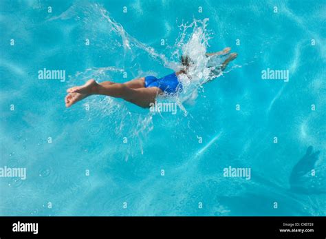 young woman diving into swimming pool Stock Photo - Alamy