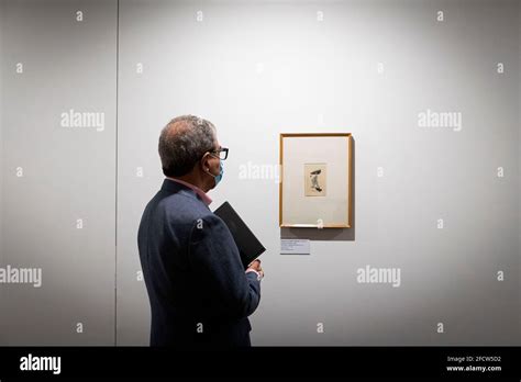 A Man Looks At A Caricature Of Amadeo Souza Cardoso During The