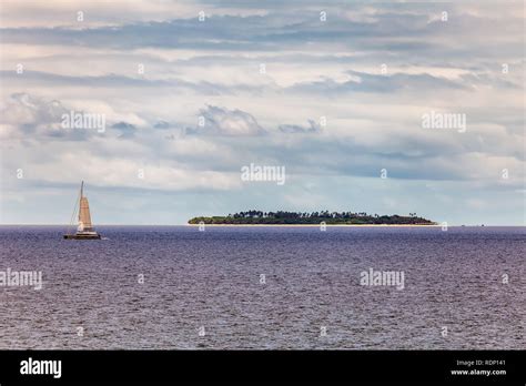 View A Small Tropical Island In The Background And A Yacht In The