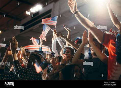 Soccer Fans In Stadium With Face Painted In Usa Flag Colors And Waving