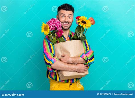 Photo Of Positive Cheerful Man Hands Hold Bunch Fresh Flowers Bag Toothy Smile Isolated On Teal