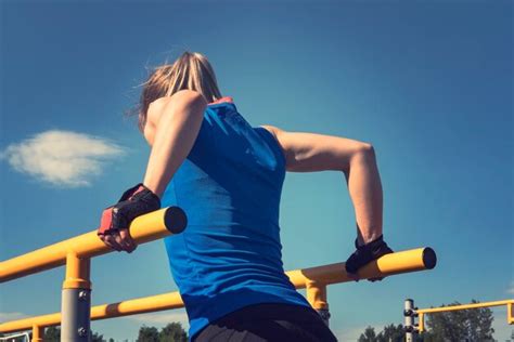 Premium Photo Beautiful Fitness Woman Doing Exercise On Parallel Bars