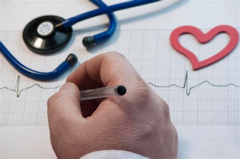 Premium Photo High Angle View Of Doctor Analyzing Pulse Trace At Desk In Hospital