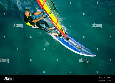 Aerial View Of Single Male Windsurfer Sailing On Azure Water Of Red Sea